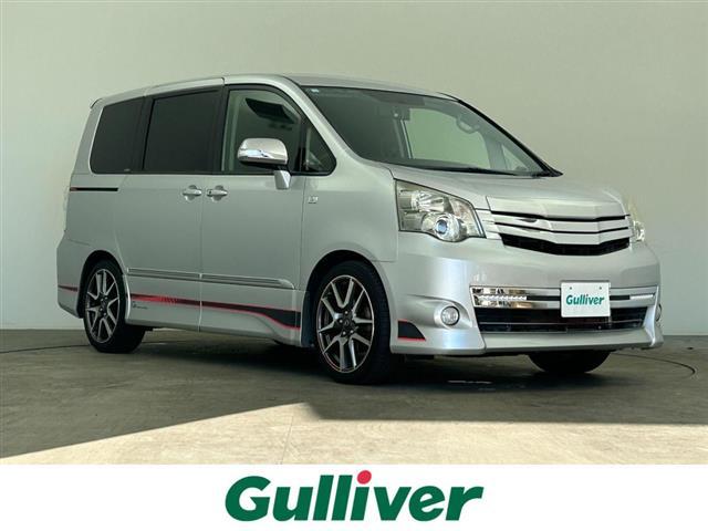 ノア(トヨタ) Ｓｉ　Ｇ’ｓ　禁煙　純正７型ナビ　両側電動スライドドア　ビルトインＥＴＣ　バックカメラ　パドルシフト　専用シート　専用フロアマット　電動格納サイドミラー　ＬＥＤビーム　ＨＩＤヘッドライト（オートライト付） 中古車画像