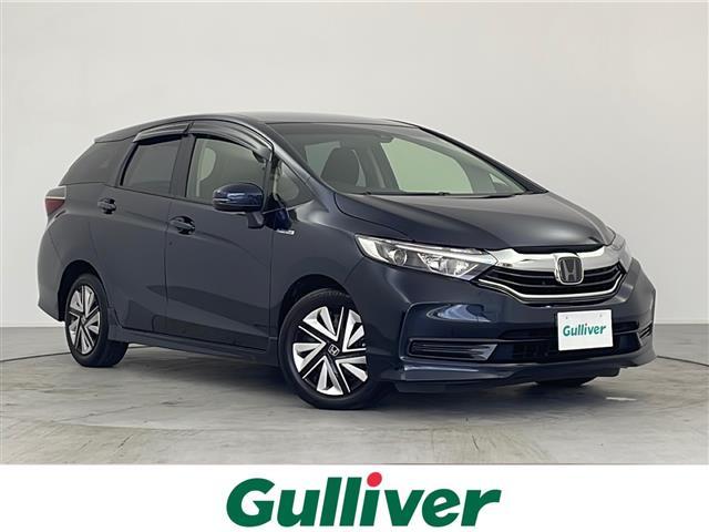 シャトル(ホンダ) ハイブリッド　ホンダセンシング　禁煙車　純正メモリナビ（ＡＭ／ＦＭ／ＣＤ／ＤＶＤ／ＢＴ／ＵＳＢ／フルセグ）　バックカメラ　ビルトインＥＴＣ　ホンダセンシング　ＣＭＢＳ　追従型クルーズコントロール　先行車発進お知らせ 中古車画像