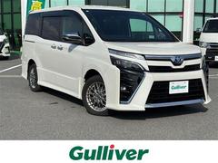 ヴォクシー ハイブリッドZS 煌III carrozzeria9インチナビ(フルセグ/BT/CD/DVD)/クルーズコントロール/バックカメラ/コーナーセンサー/衝突軽減/両側パワスラ/ハーフレザー/後席サンシェード/シートヒーター 中古車画像