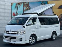 ハイエースワゴン GL ポップアップルーフ 3人掛け2列REVOシート 対面シートアレンジ ベッドアレンジ センターテーブル 硬質フローリング 防虫ネット フリップダウンモニター ナビ カメラ パワースライド LEDテール 中古車画像