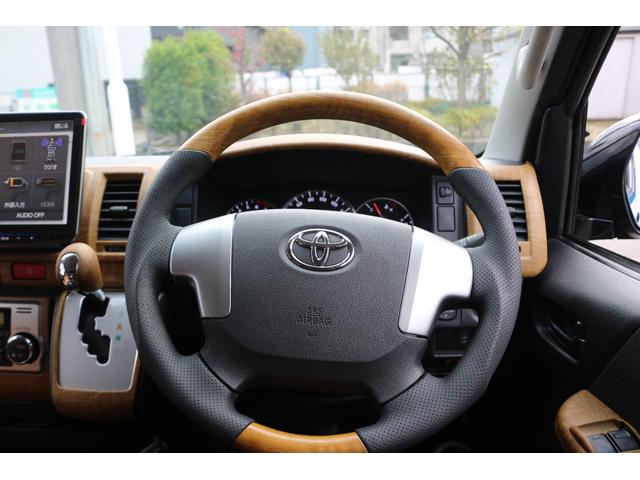 ハイエースバン ロングスーパーＧＬ　丸目フェイスツートンカラーＤＥＡＮ１６インチアルミクラシックオーバルタイヤＢＩＧ－ＸナビＥＴＣフリップダウンモニターメティオサウンドＦＬＥＸシートカバーベッドキット黄木目インテリアパネルステアリング（25枚目）