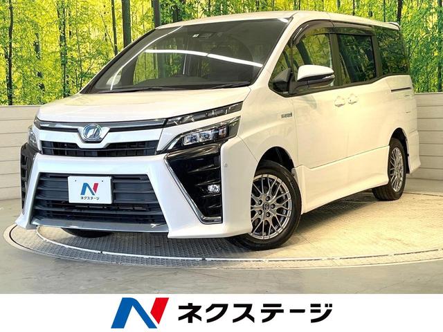 トヨタ ヴォクシー ハイブリッドＺＳ　純正１０型ナビ　１２型フリップダウンモニター　禁煙車　トヨタセーフティセンス　両側電動スライドドア　純正１６インチアルミホイール　バックカメラ　Ｂｌｕｅｔｏｏｔｈ接続　フルセグＴＶ　ＥＴＣ