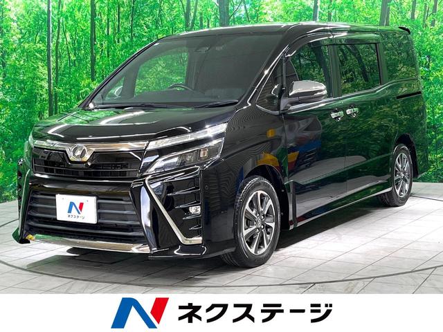 ヴォクシー ＺＳ　煌　後期　特別仕様車　禁煙車　衝突軽減装置　１２型後席モニター　７人乗り　純正９型ナビ　両側電動スライドドア　ＬＥＤヘッドライト　アイドリングストップ　純正１６インチアルミホイール（1枚目）