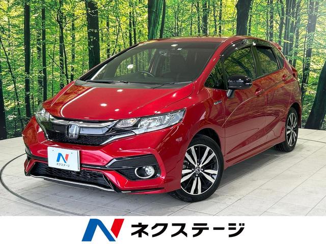 ホンダ フィットハイブリッド Ｓ　ホンダセンシング　８型ナビ　バックカメラ　ホンダセンシング　フルセグＴＶ　禁煙車　ｂｌｕｅｔｏｏｔｈ　車線逸脱警報　レーダークルーズ　スマートキー　ＥＴＣ　純正１６インチアルミ　ドラレコ　パドルシフト　電動格納ミラー