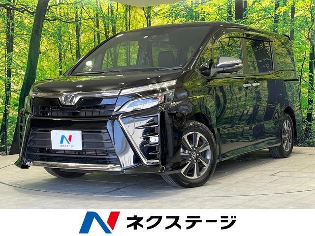 ヴォクシー ＺＳ　煌　禁煙車　１０型ＳＤナビ　後席モニター　両側電動スライド　セーフティーセンス　フルセグＴＶ　Ｂｌｕｅｔｏｏｔｈ再生　ドラレコ　ＥＴＣ　純正１６インチアルミ　リアオートエアコン　クルーズコントロール（1枚目）