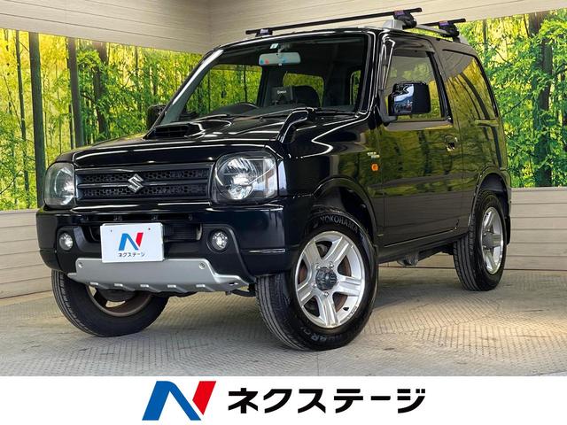 スズキ ジムニー ワイルドウインド　パートタイム４ＷＤ　ポータブルナビ　ＣＤオーディオ　シートヒーター　ＥＴＣ　　キーレスキー　フォグランプ　ルーフレール　ターボ　ヘッドライトレベライザー　電動格納ミラー　背面タイヤ　プライバシーガラス