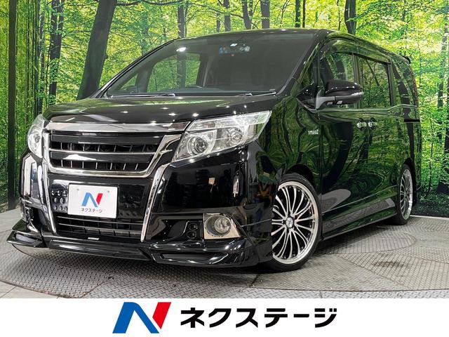 トヨタ エスクァイア ハイブリッドＧｉ　ＴＲＤフルエアロ／ＴＲＤグリル　禁煙車　純正９型ＳＤナビ　フリップダウンモニター　バックカメラ　両側パワースライドドア　ＥＴＣ　ドライブレコーダー　Ｂｌｕｅｔｏｏｔｈ　セーフティセンスＣ