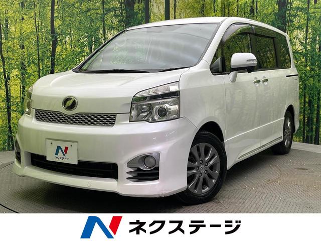 ヴォクシー ＺＳ　煌ＩＩＩ　両側電動ドア　純正ＳＤナビ　バックカメラ　禁煙車　ハーフレザーシート　スマートキー　ＨＩＤヘッド　ビルトインＥＴＣ　オートライト　デュアルエアコン　純正１６インチアルミ　Ｂｌｕｅｔｏｏｔｈ　ＣＤ（1枚目）