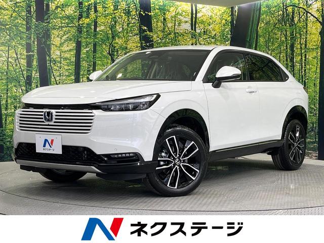 ヴェゼル ｅ：ＨＥＶ　Ｚ　登録済未使用車　純正９型ディスプレイオーディオ　全周囲カメラ　衝突被害軽減システム　レーダークルーズ　電動リアゲート　ハーフレザーシート　コーナーセンサー　ＥＴＣ２．０　オートハイビーム　車線逸脱警報（1枚目）