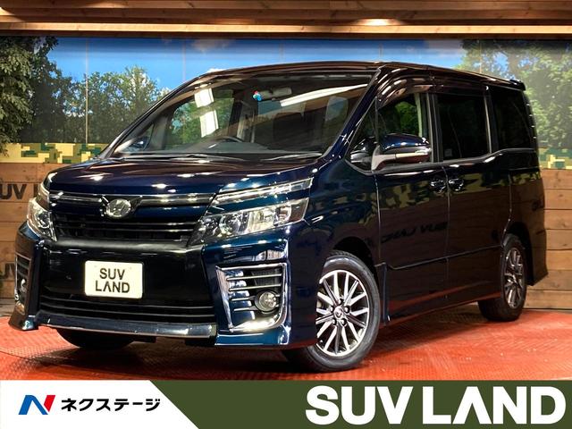 ヴォクシー ＺＳ　両側電動ドア　純正ＳＤナビ　バックカメラ　衝突被害軽減システム　禁煙車　スマートキー　ＬＥＤヘッド　ビルトインＥＴＣ　オートライト　オートエアコン　純正１６インチアルミ　リアエアコン（1枚目）