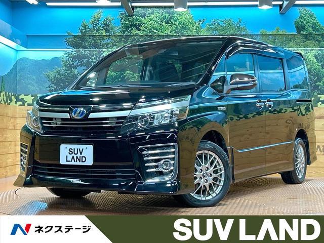 ヴォクシー ハイブリッドＺＳ　煌ＩＩ　禁煙　後席モニター　ＴＲＤエアロ　ＢＩＧ－Ｘ１１インチナビ　バックカメラ　両側電動ドア　ＥＴＣ　オートマチックハイビーム　トヨタセーフティーセンス　ＬＥＤヘッドライト　純正１６インチアルミ（1枚目）
