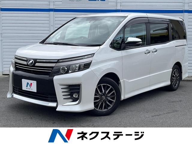 ヴォクシー ＺＳ　煌ＩＩ　両側電動スライドドア　純正ＳＤナビ　後席モニター　バックカメラ　プリクラッシュセーフティ　スマートキー　ＬＥＤヘッド　ビルトインＥＴＣ　オートハイビーム　オートライト　純正１６インチアルミ（1枚目）