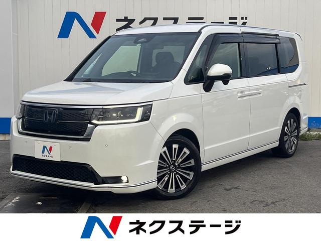 沖縄県の中古車ならステップワゴン ｅ：ＨＥＶスパーダ　プレミアムライン　１年保証付　両側電動ドア　純正ＳＤナビ　全周囲カメラ　衝突被害軽減システム　レーダークルーズ　禁煙車　電動リアゲート　ハーフレザーシート　コーナーセンサー　スマートキー　ＬＥＤヘッド　ＥＴＣ２．０