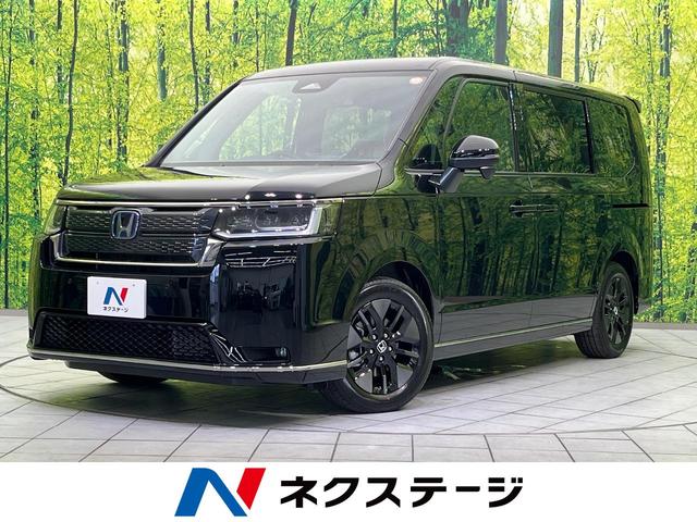 ステップワゴンスパーダ（ホンダ）ｅ：ＨＥＶスパーダ　登録済未使用車　両側電動ドア　純正１１．４インチメモリーナビ　バックカメラ　ホンダセンシング　レーダークルーズ　電動リアゲート　ハーフレザーシート　コーナーセンサー　スマートキー　ＬＥＤヘッド 中古車画像