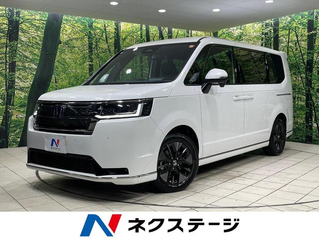 ステップワゴンスパーダ（ホンダ）ｅ：ＨＥＶスパーダ　両側電動ドア　純正１１型ナビ　バックカメラ　衝突被害軽減システム　Ｂｌｕｅｔｏｏｔｈ接続　レーダークルーズ　電動リアゲート　ハーフレザーシート　コーナーセンサー　スマートキー　ＬＥＤヘッド 中古車画像