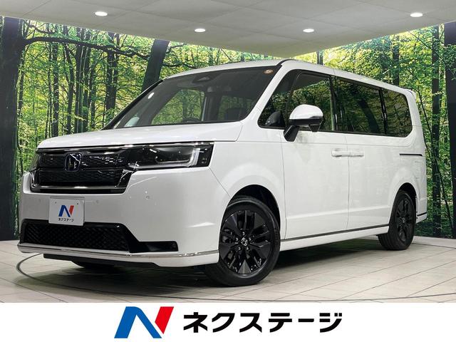 ステップワゴン(ホンダ) ｅ：ＨＥＶスパーダ　登録済未使用車　純正１１．４型ナビ　両側パワースライドドア　バックカメラ　ホンダセンシング　アダプディブクルコン　パワーバックドア　シートヒーター　二列目オットマン　ハーフレザーシート　パドルシフト 中古車画像