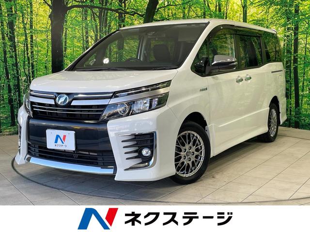 ヴォクシー(トヨタ) ハイブリッドＺＳ　煌ＩＩ　禁煙車　純正１０型ナビ　フリップダウンモニター　セーフティセンス　両側電動ドア　ＬＥＤヘッド　バックカメラ　ＥＴＣ　純正１６インチアルミ　スマートキー　ワンオーナー 中古車画像