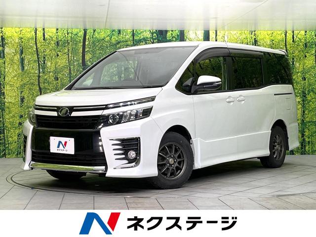 ヴォクシー(トヨタ) ＺＳ　禁煙車　純正９型ナビ　Ｂｌｕｅｔｏｏｔｈ／ＣＤ／ＤＶＤ再生　フルセグ　バックカメラ　両側電動スライドドア　デジタルインナーミラー　ＬＥＤヘッド／フォグ　オートライト　デュアルエアコン　ＥＴＣ 中古車画像
