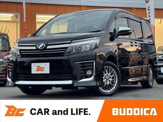 ヴォクシー(トヨタ) ハイブリッドＺＳ　煌ＩＩ　車検整備付　禁煙車　フルセグナビ　セーフティセンスＣ　電動スライドドア　Ｐスタート　Ｂモニター　ＥＴＣ　ＬＥＤ　Ａハイビーム　先行車発進告知機能　クルコン　Ａライト　革巻きステアリング　ＢＴ　ステリモ 中古車画像